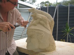 John working on sandstone piece 'Eco Warrior"